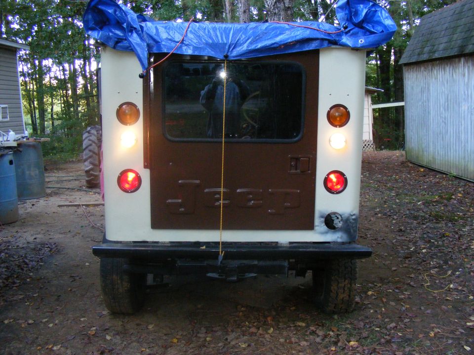 Jeep CJ-5 rear, cream and brown, with blue tarp on roof