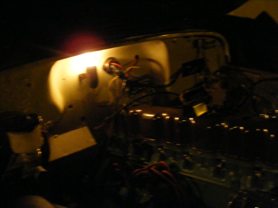 Engine bay with light and wiring. Supermotors.net logo visible