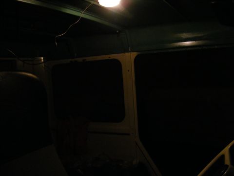Interior view of a dark vehicle with a light on the ceiling