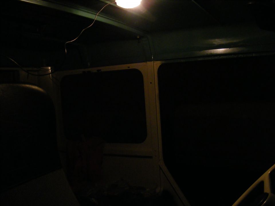Interior view of a dark vehicle with a light on the ceiling