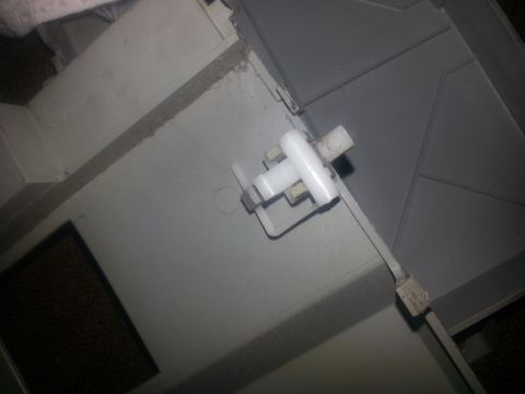 1994 Ford Bronco - Close-up of interior plastic trim a white plastic latch mechanism.