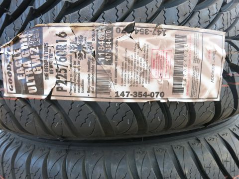 1991 Ford LTD Crown Victoria - Close-up of a tire label showing size P225/60R16 and brand Goodyear Eagle Ultra Grip GW2.