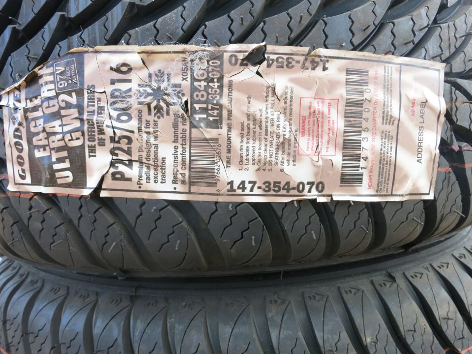 Stack of Goodyear Eagle Ultra Grip GW2 tires with P225/60R16 size on the label