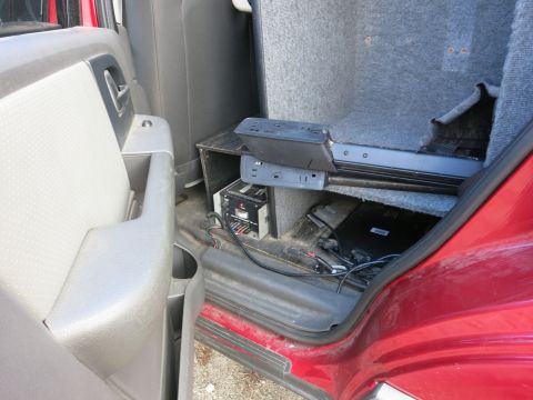 1991 Ford LTD Crown Victoria - Aftermarket electronics installed in the rear interior of a red vehicle.