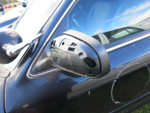 1991 Ford LTD Crown Victoria - The side mirror housing on this vehicle is damaged and missing its mirror cover.