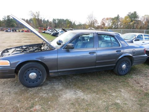 1991 Ford LTD Crown Victoria - A gray Ford Crown Victoria sedan sits with its hood open, parked outdoors.