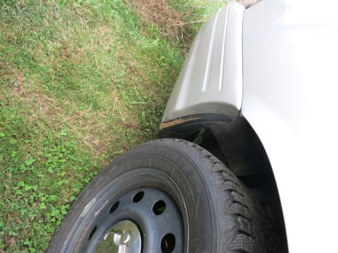 1991 Ford LTD Crown Victoria - Detail shot of a vehicle's fender and wheel, showing part of the tire and the body panel.