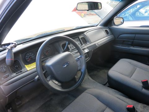 1991 Ford LTD Crown Victoria - Interior of a Ford Crown Victoria, showing the dashboard and seats. Another vehicle is visible through the passenger window.