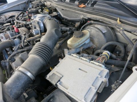 1991 Ford LTD Crown Victoria - Close-up of the engine bay of a 1991 Ford Crown Victoria LTD, highlighting various components and wiring.