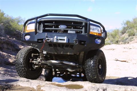 1994 Ford Bronco - This modified Ford truck is equipped with a heavy-duty bumper and winch, ready for off-road adventures.
