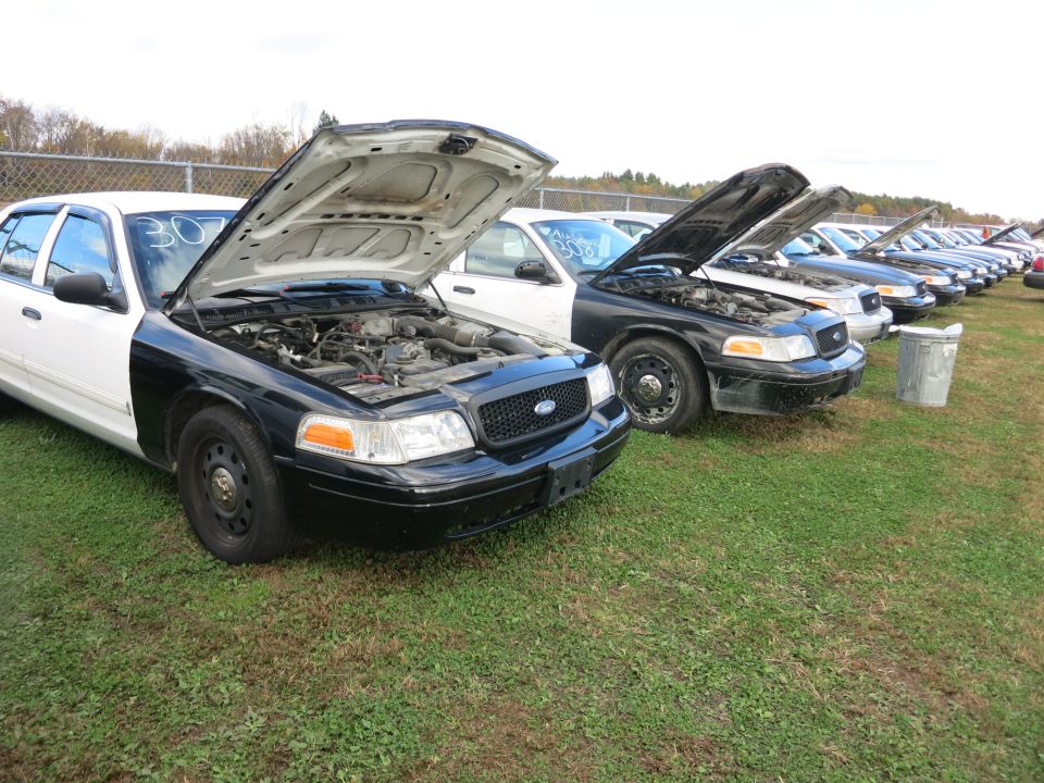 1991 Ford Crown Victoria LTD police cars lined up with hoods open