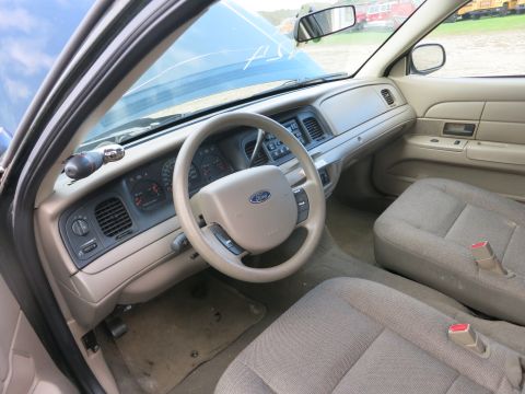 1991 Ford LTD Crown Victoria - The interior of a Ford Crown Victoria shows the dashboard, steering wheel, and seats with the hood open.