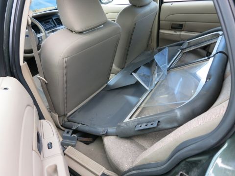 1991 Ford LTD Crown Victoria - Interior view of a car with a large object, possibly a window frame, occupying the back seat.