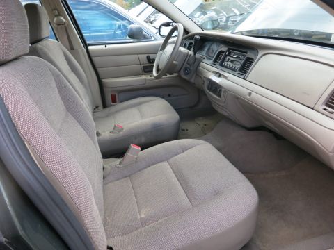 1991 Ford LTD Crown Victoria - Interior view of a car, showing the seats and dashboard, with another vehicle visible outside.