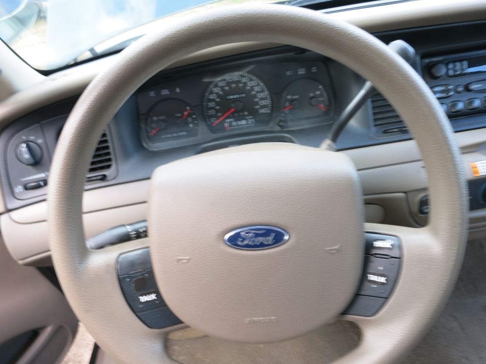 Interior view of a Ford steering wheel and dashboard with visible gauges