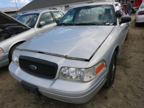 1991 Ford LTD Crown Victoria - A silver Ford Crown Victoria is parked outside with its hood open, next to another vehicle.