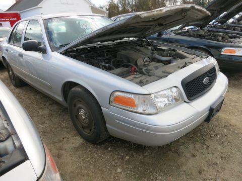 1991 Ford LTD Crown Victoria - A silver Ford Crown Victoria sits in a lot with its hood open, revealing the engine compartment.