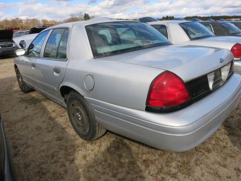 1991 Ford LTD Crown Victoria - This silver sedan, likely a 2003 Ford Crown Victoria, is seen in a vehicle registry lot.