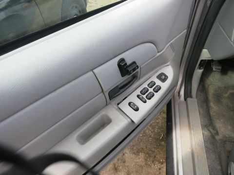 1991 Ford LTD Crown Victoria - Interior door panel of a 1991 Ford Crown Victoria LTD showing power window and lock controls.