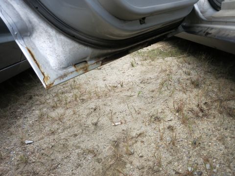 1991 Ford LTD Crown Victoria - Opened car door reveals a rusted sill and the interior floor area.