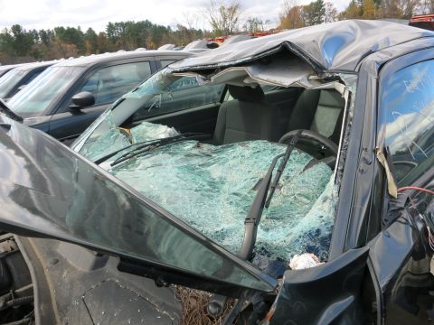 1991 Ford LTD Crown Victoria - Photograph of a wrecked sedan with collapsed roof, not a technical document.