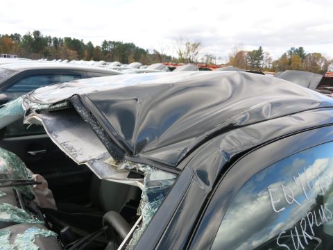 1991 Ford LTD Crown Victoria - Photograph of crash damage to a sedan roof, not a technical document.