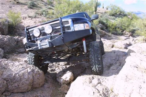 1994 Ford Bronco - This modified truck navigates a challenging rocky trail, its off-road capabilities.