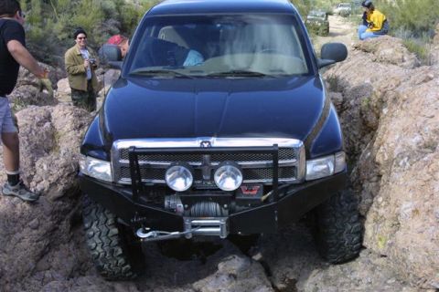 1994 Ford Bronco - This Dodge Ram is off-roading on a rocky trail, with another vehicle in the distance.