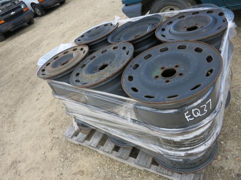 1991 Ford LTD Crown Victoria - Photograph of steel wheels on a pallet, not a technical document.