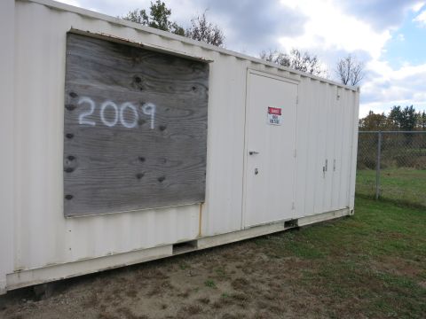 1991 Ford LTD Crown Victoria - Photograph of a container-mounted generator enclosure, not a technical document.