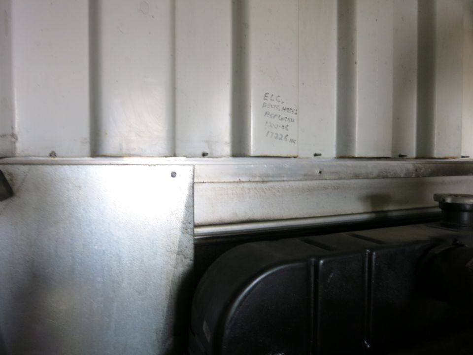 Interior of a generator enclosure with handwriting on the wall