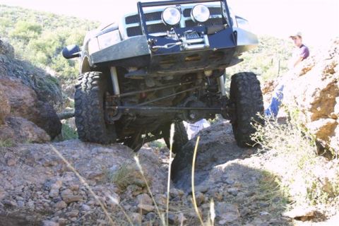 1994 Ford Bronco - A modified truck navigates a challenging rocky terrain, its suspension and off-road capabilities.