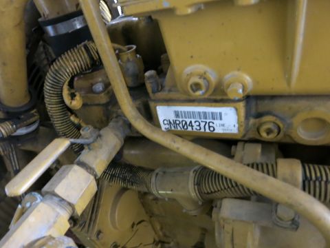 1991 Ford LTD Crown Victoria - Caterpillar engine identification plate showing serial number SNR04376 attached to the engine block amid wiring and hoses.