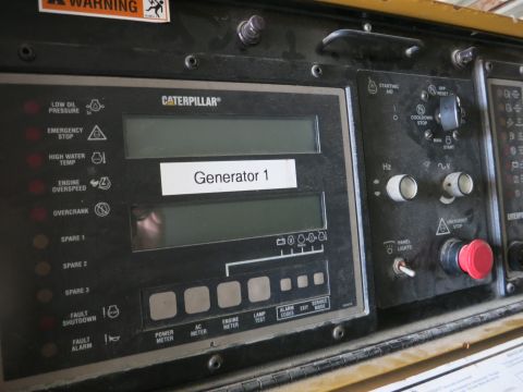 1991 Ford LTD Crown Victoria - Photograph of a Caterpillar generator control panel with fault indicators and a Generator 1 label, not a document.