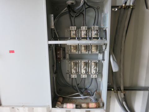 1991 Ford LTD Crown Victoria - Photograph of an open electrical disconnect/fused-switch cabinet with wiring, not a document.
