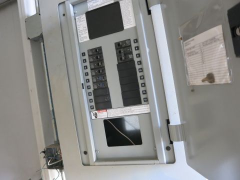 1991 Ford LTD Crown Victoria - Photograph of an open electrical breaker panel/load center with numbered circuits, not a document.