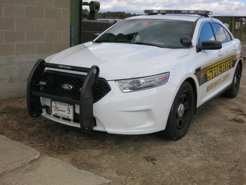 1991 Ford LTD Crown Victoria - Photograph of a Merrimack County Sheriff Ford Taurus patrol car, front view, not a document.