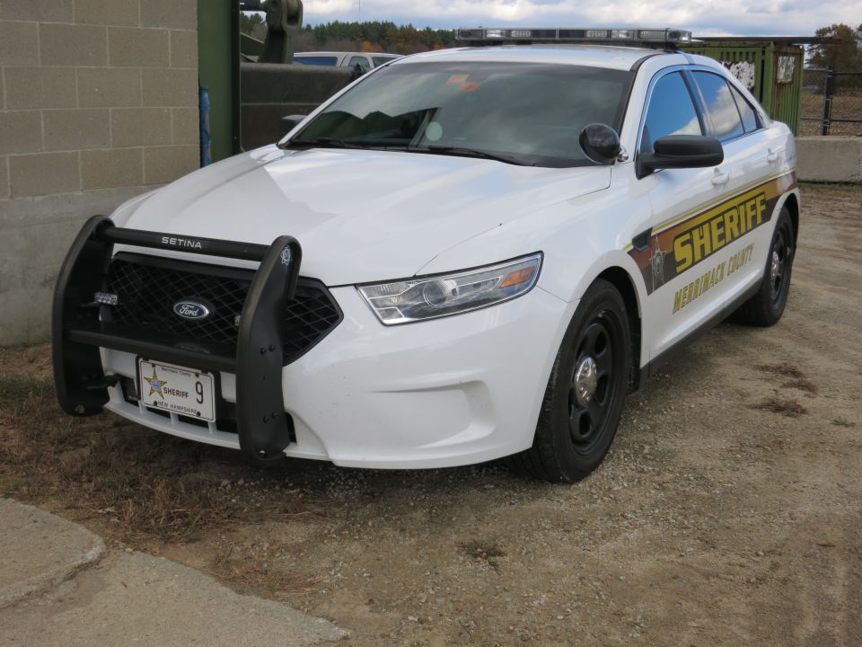 White Ford Taurus Sheriff patrol car, front three-quarter view