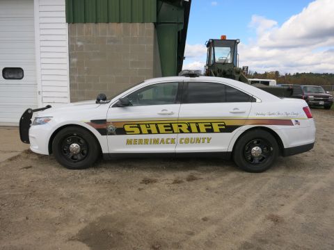 1991 Ford LTD Crown Victoria - Photograph of a Merrimack County Sheriff Ford Taurus patrol car in side profile, not a document.