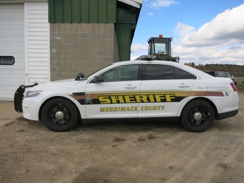 1991 Ford LTD Crown Victoria - Photograph of a Merrimack County Sheriff Ford Taurus patrol car in side profile, not a document.