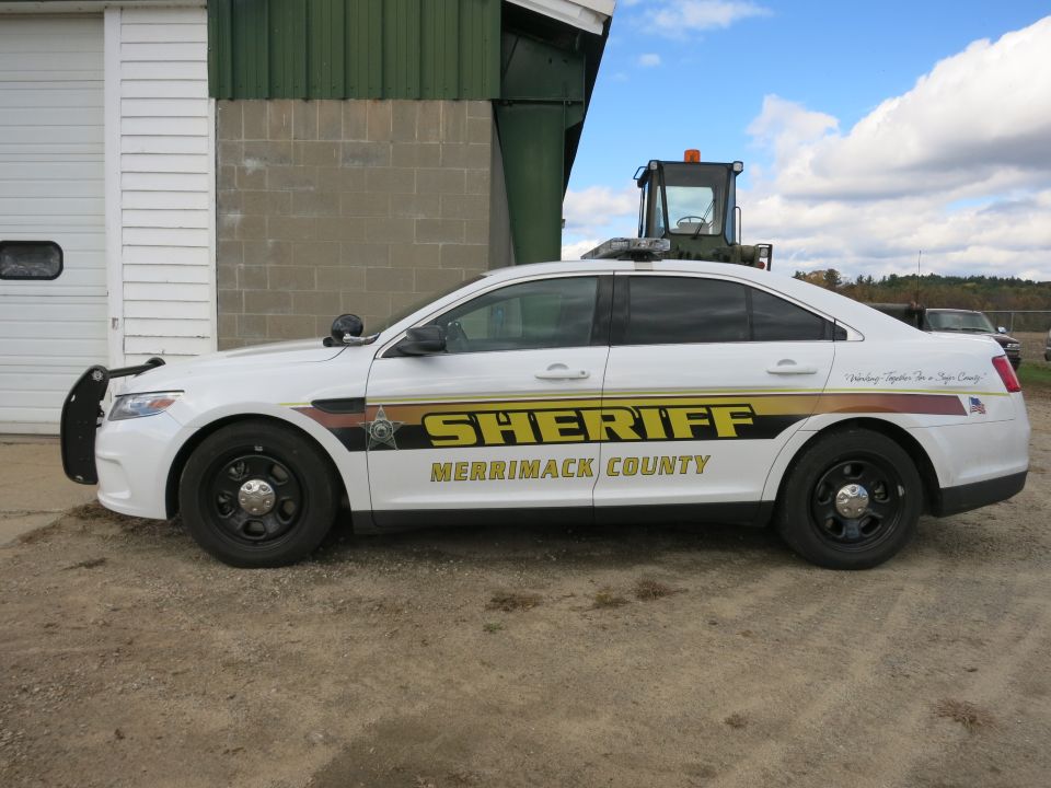White Ford Taurus Merrimack County Sheriff patrol car, side profile