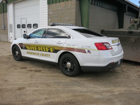 1991 Ford LTD Crown Victoria - Photograph of a Merrimack County Sheriff Ford Taurus patrol car, rear three-quarter view, not a document.