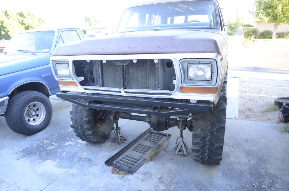 Front view of a lifted 1979 Ford Bronco with a custom bumper.