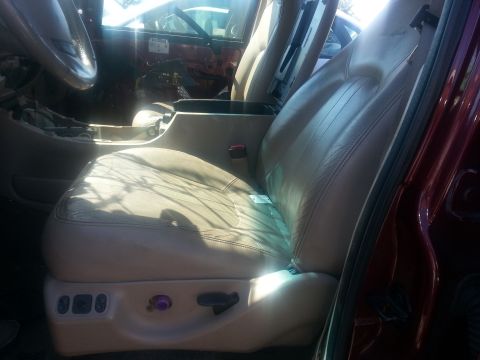 1994 Ford Bronco - Photograph of a vehicle interior showing a tan leather front bucket seat with power-seat controls.