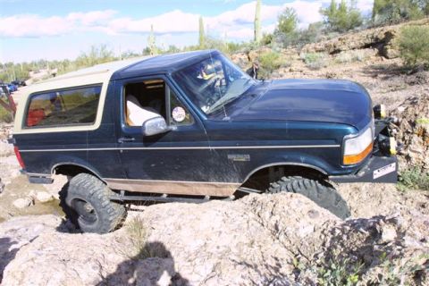 1994 Ford Bronco - This 1994 Ford Bronco navigates a rocky trail, demonstrating its off-road capabilities.
