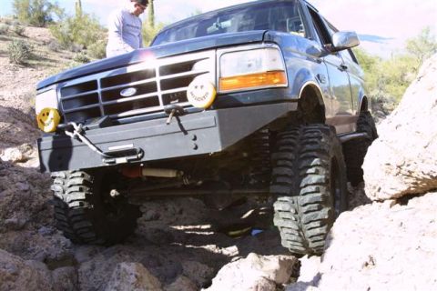 1994 Ford Bronco - This 1994 Ford Bronco is navigating a rocky trail with its large off-road tires.