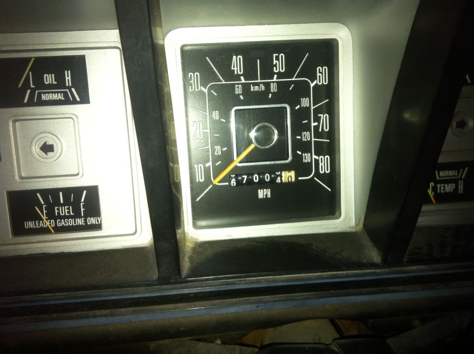 Vehicle dashboard showing speedometer at 10 MPH and odometer at 67004, with fuel gauge near full.