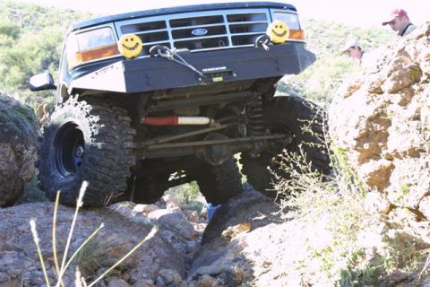1994 Ford Bronco - This modified 1992 Ford Bronco is navigating a rocky trail with its front end angled upwards.