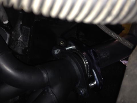 1992 Ford F-150 - Close-up view of an exhaust pipe connection, showing a clamp and bolts.