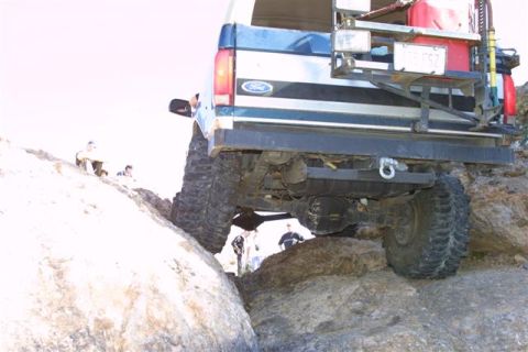 1994 Ford Bronco - This 1994 Ford Bronco navigates a rocky trail, its off-road capabilities with large tires and a rear-mounted spare.